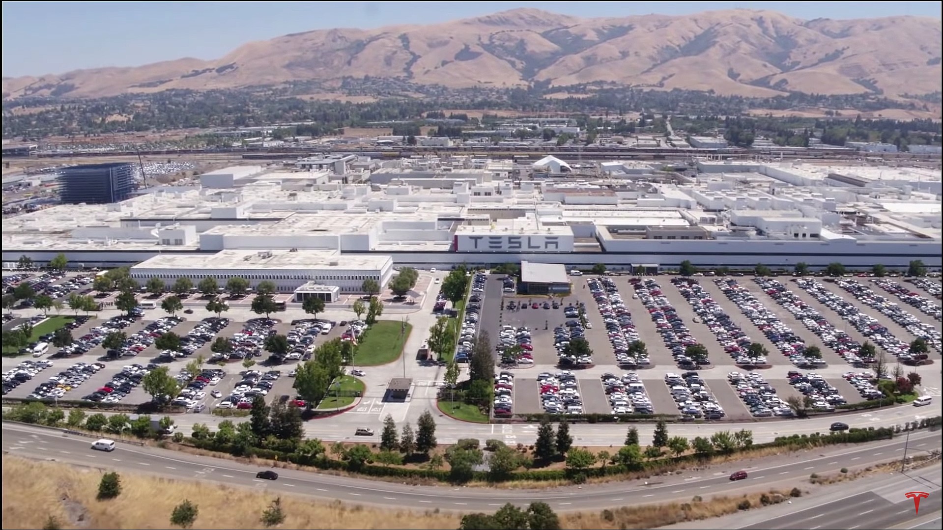 Obrazek przedstawia fabrykę firmy Tesla znajdującą się w kalifornijskim mieście Fremont.